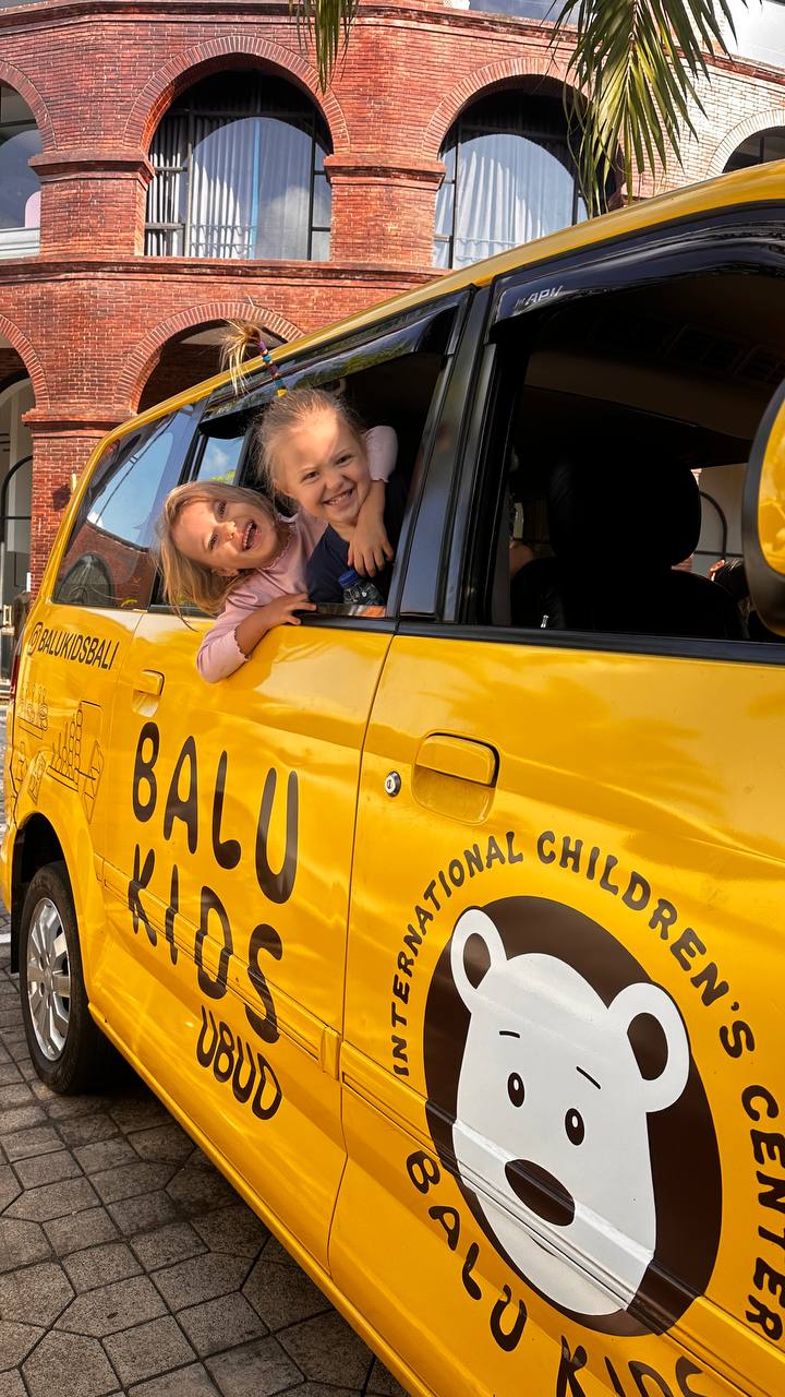 The bright yellow Balu Kids minibus used for the transfer service near Ubud